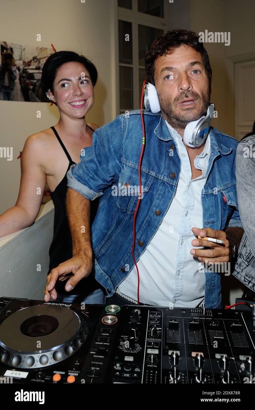 File Photo - Safia Bahmed-Schwartz and Philippe Cerboneschi Zdar (Cassius) attending the Levi's Party in Paris, France, on September 10, 2014. Philippe Cerboneschi (also known as 'Zdar'), one half of of French dance duo Cassius, accidentally died in Paris on Wednesday, his agent has said. 'He made an accidental fall, through the window of a high floor of a Parisian building,' said Sebastien Farran, without giving further details. Cerboneschi formed Cassius with Hubert Blanc-Francard (aka Boombass) in 1996. They produced for bands such as Phoenix, Beastie Boys, Franz Ferdinand and French hip ho Stock Photo