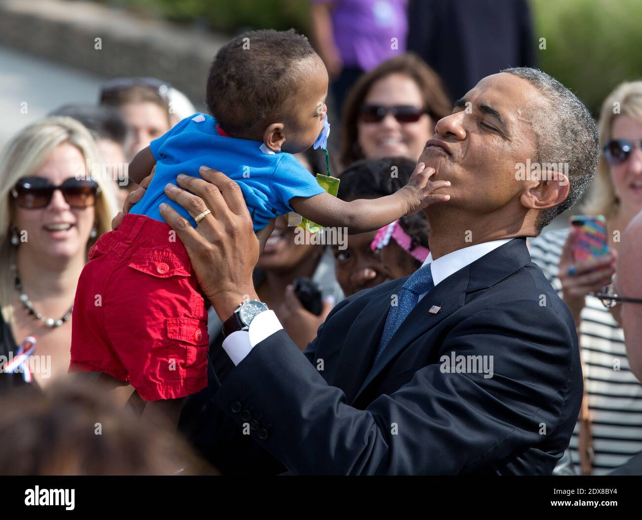 President Barack Obama holds up Larnell Maurice Perry, Jr. (13 months) during a ceremony at the Pentagon to mark the 13th anniversary of the September 11th, 2001 terrorist attacks, in Washington, DC, USA on September 11, 2014. Photo by Martin H. Simon/Pool/ABACAPRESS.COM The boy is the grandson of Angeline C. Carter, who died in the Pentagon attack on 9-11-01. Stock Photo