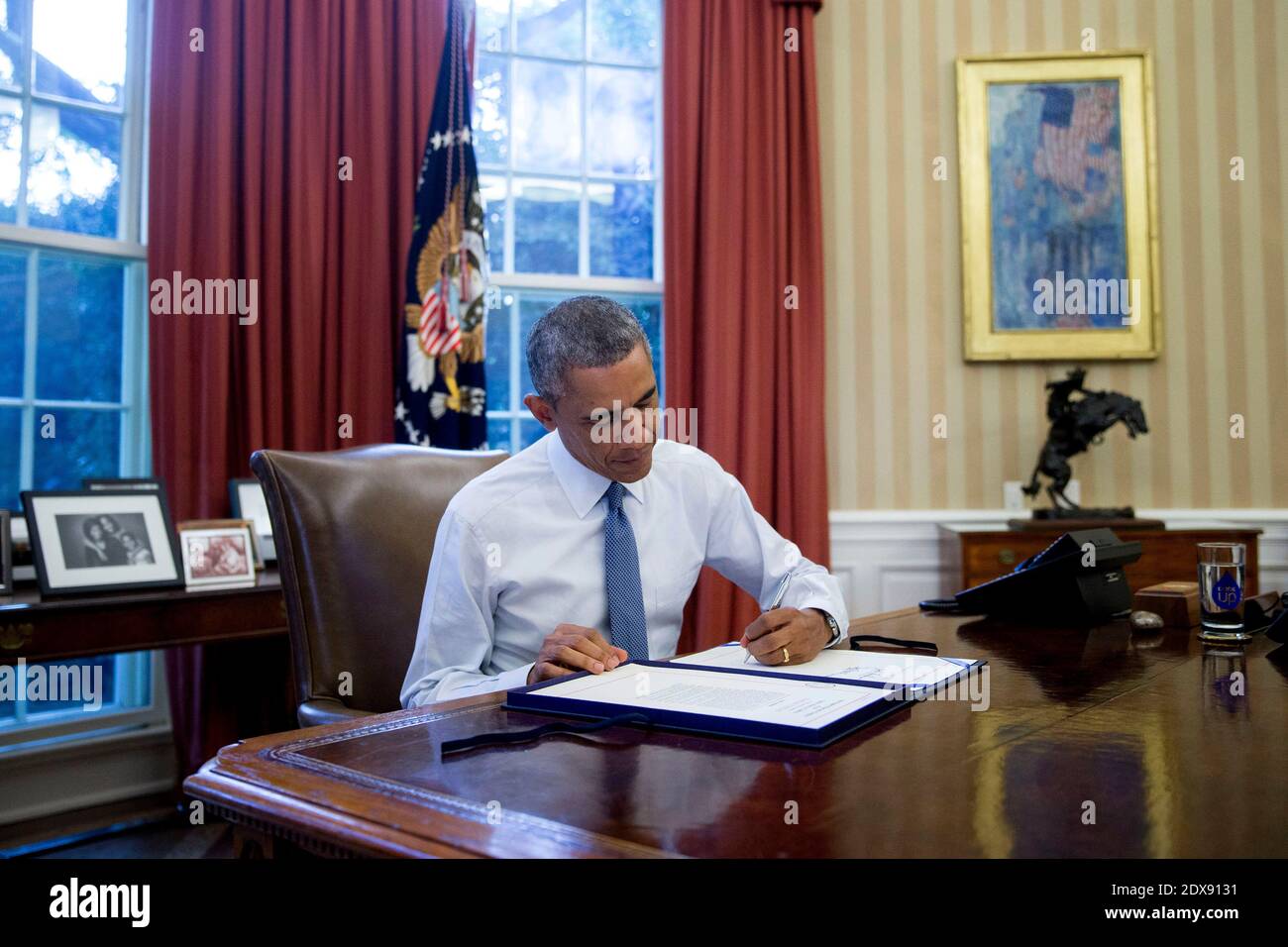 President Barack Obama sign H.R. Res. 124, Continuing Appropriations Resolution, 2015, in the Oval Office of the White House in Washington, DC, USA., on Friday, September 19, 2014. Congress bipartisan passage of President Obama plan to arm and train Syrian rebels sets up a broader debate over the use of U.S. military force when lawmakers return after the Nov. 4 election. Yesterday?s 78-22 Senate vote came a day after the House passed the measure. Photo by Andrew Harrer/Pool/ABACAPRESS.COM Stock Photo