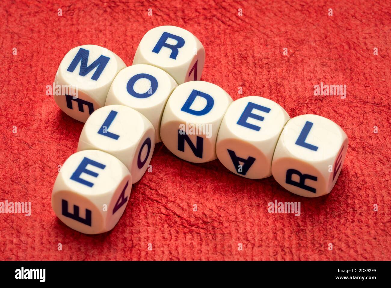 role model crossword in letter dices against textured handmade paper, inspiration and leadership concept Stock Photo