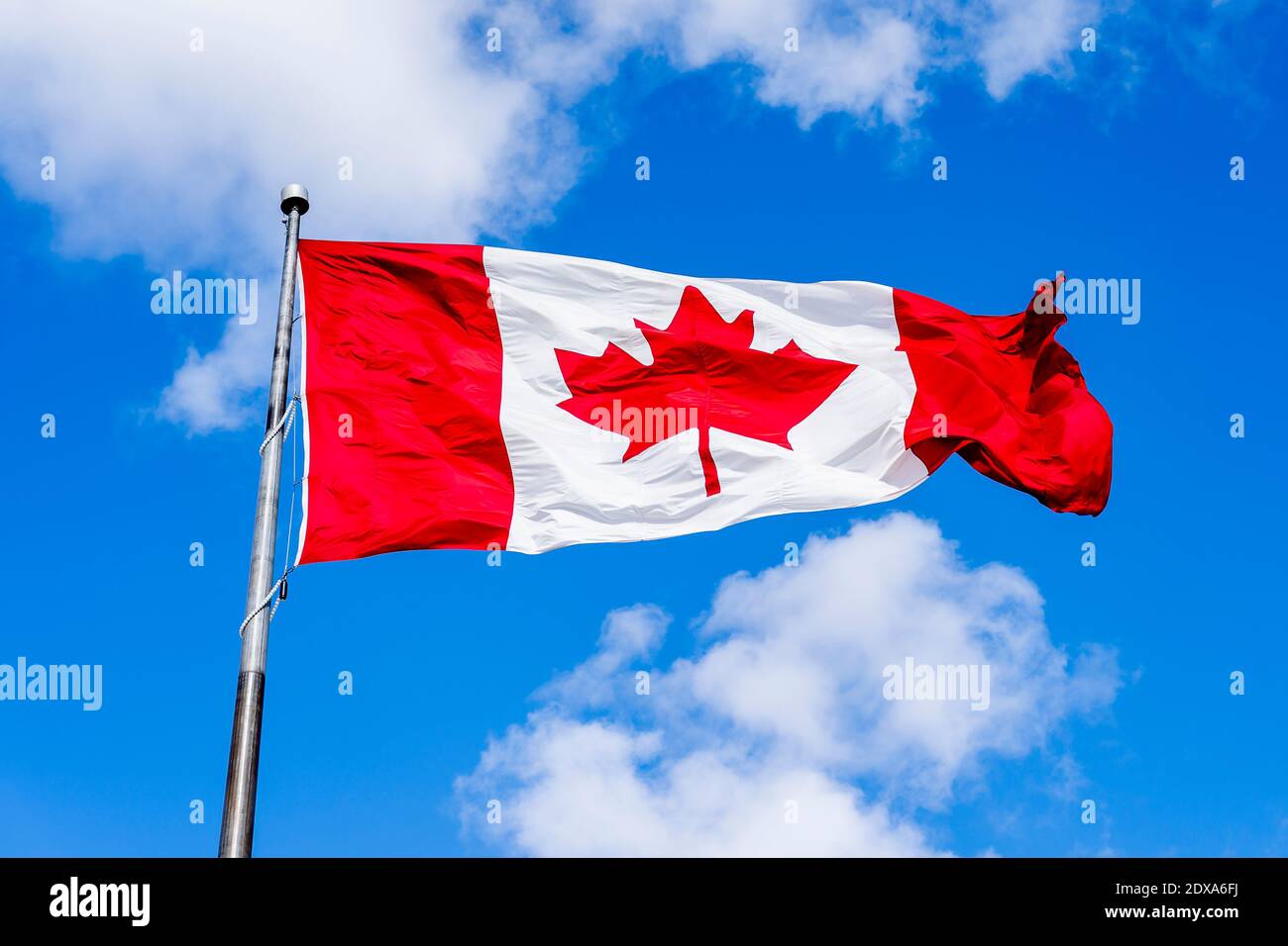 Canadian flag with blue sky in background Stock Photo