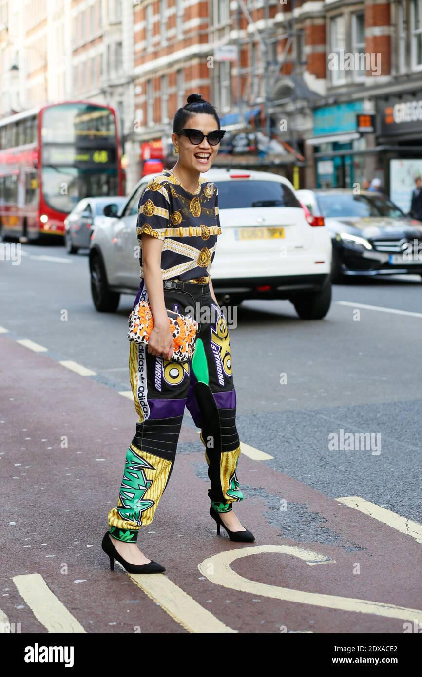 Kat Yeung, street style, after Vivienne Westwood Red Label fashion show,  spring-summer 2015, CSM, Victoria House, Southampton Row Entrance, London,  UK, on september 14th 2014. She's wearing a Versace bag, Versus top,