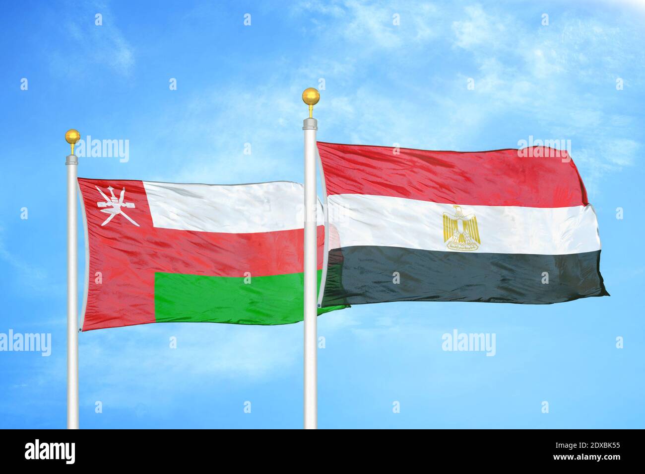 Oman and Egypt two flags on flagpoles and blue sky Stock Photo