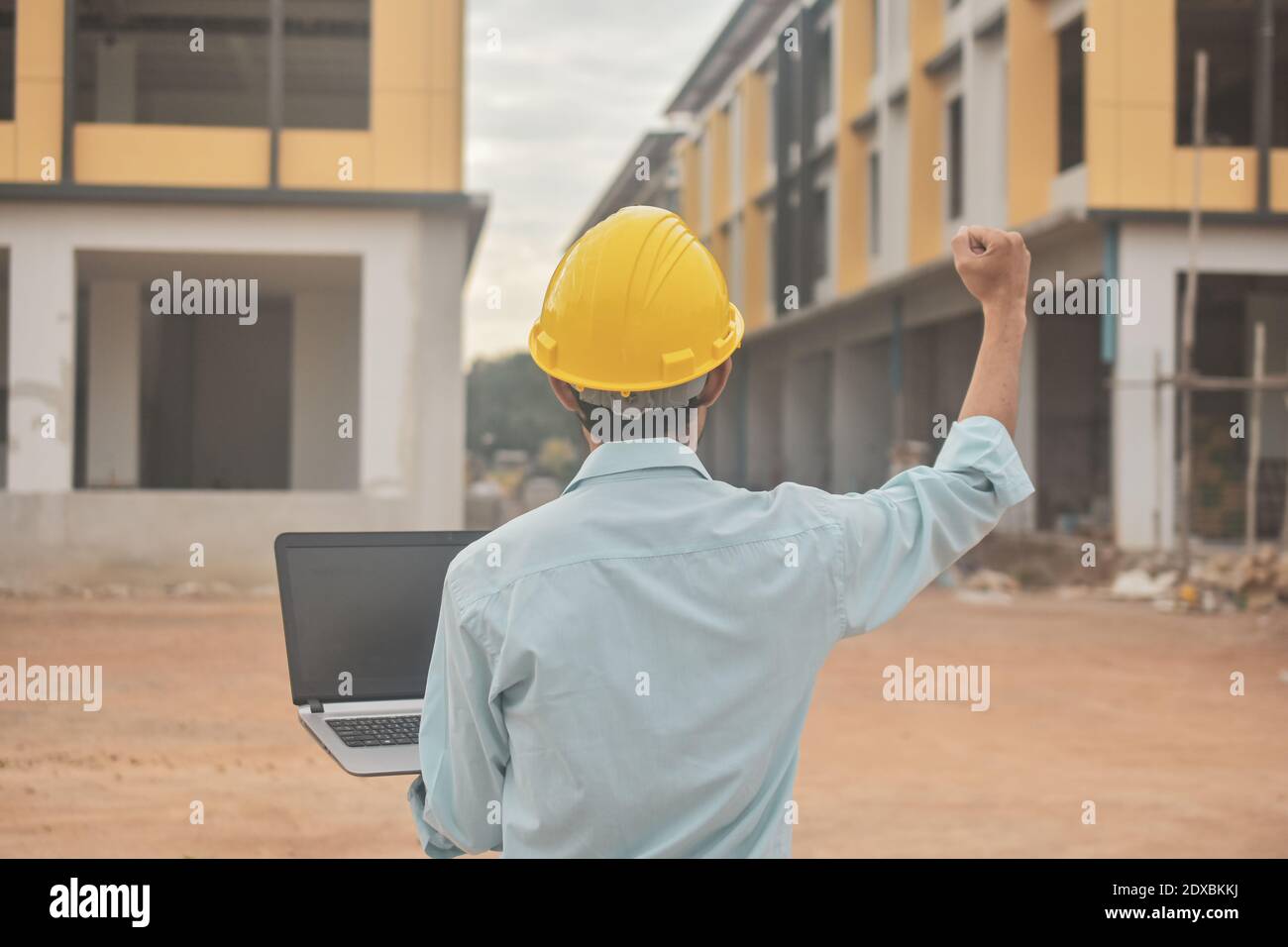 Engineering construction holding computer notebook inspection work at estate building project Stock Photo