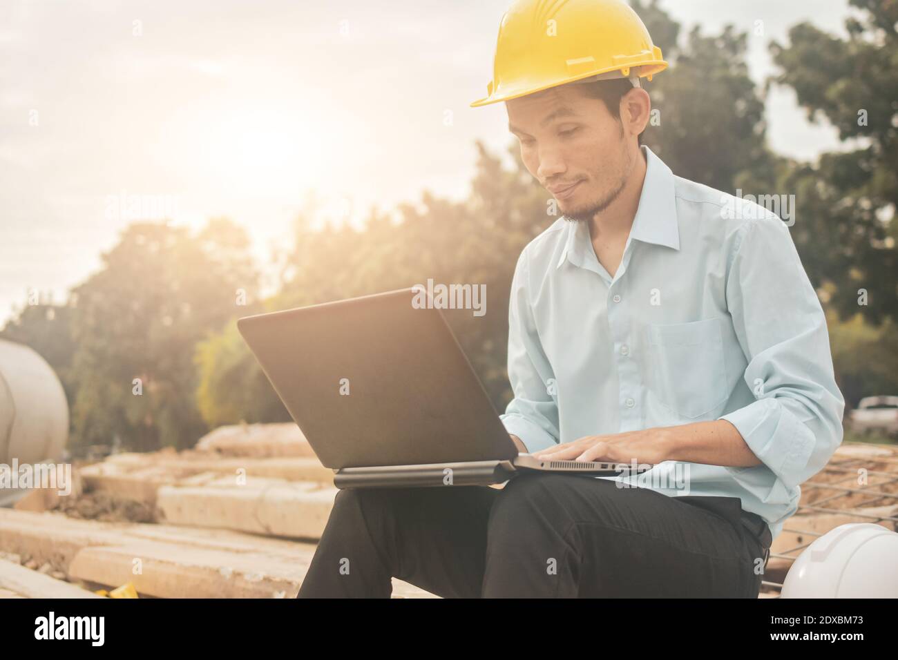 Engineering construction holding computer notebook inspection work at estate building project Stock Photo