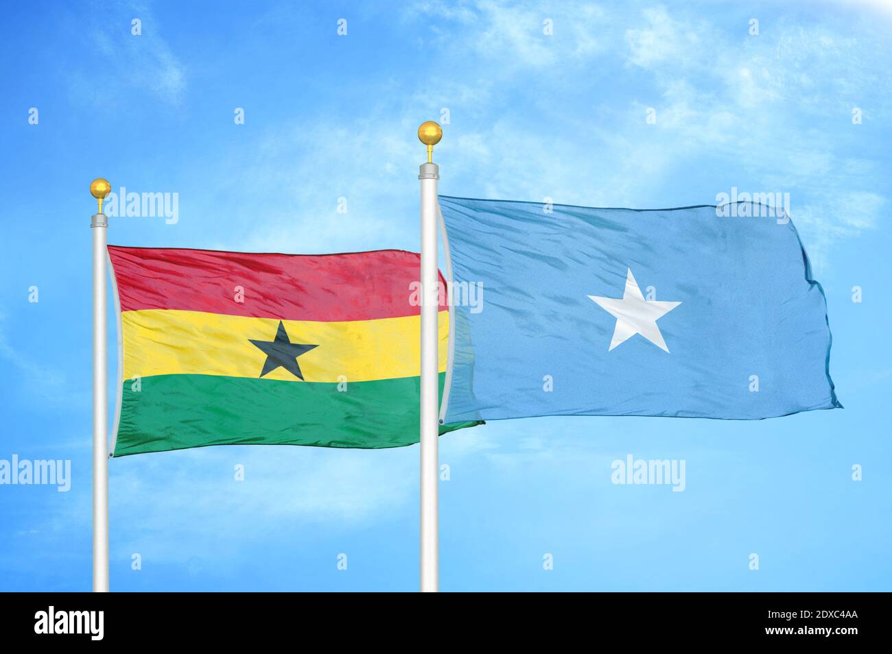 Ghana and Somalia two flags on flagpoles and blue sky Stock Photo