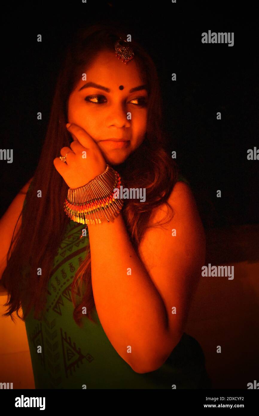 Young Woman Wearing Jewelry And Bindi In Darkroom Stock Photo Alamy