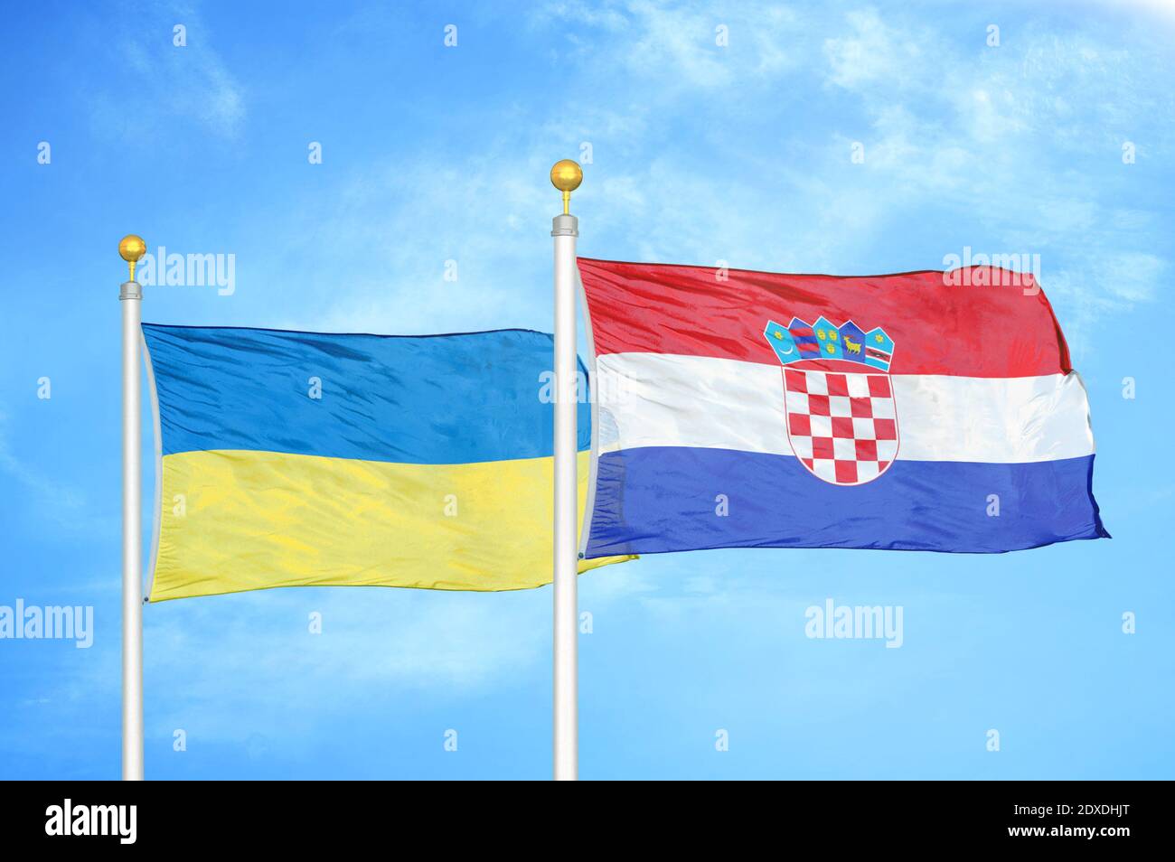 Ukraine and Croatia two flags on flagpoles and blue sky Stock Photo