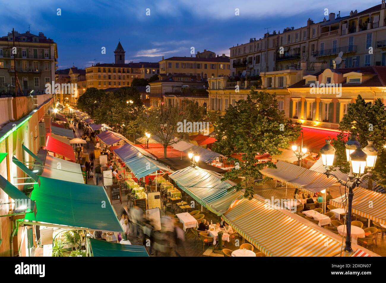 France, Provence-Alpes-Cote dAzur, Nice, Restaurant canopies stretching along Cours Saleya at dusk Stock Photo