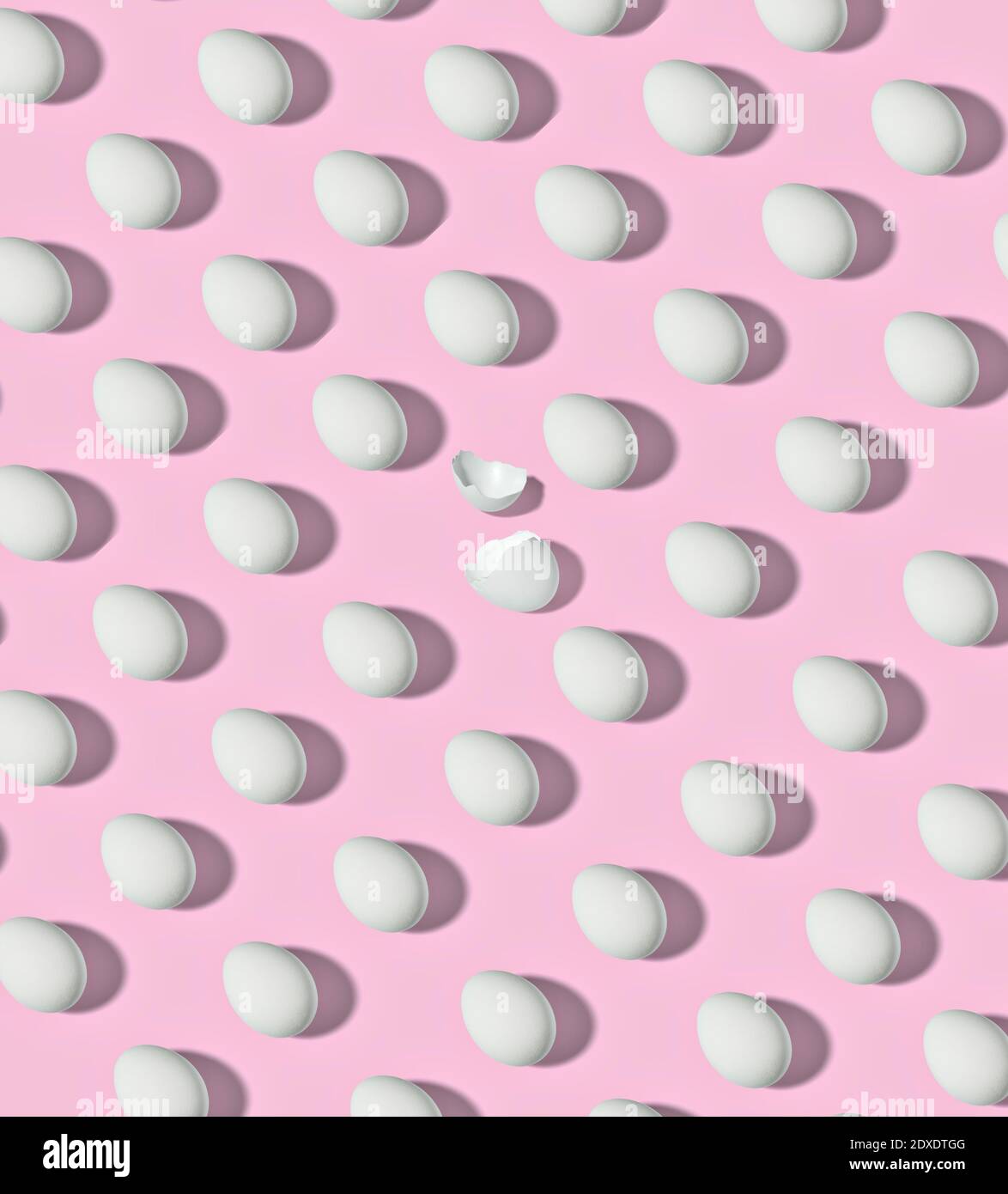 Pattern of white chicken eggs against blue background Stock Photo