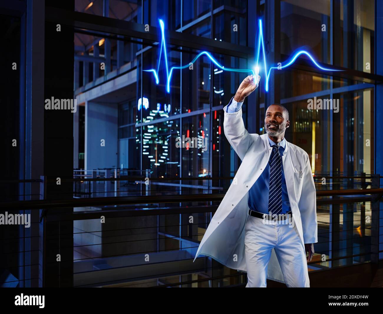 Male cardiologist analyzing pulse trace at hospital Stock Photo
