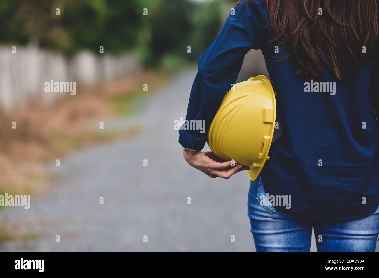Engineering hold yellow hard hat safety work place outdoors background