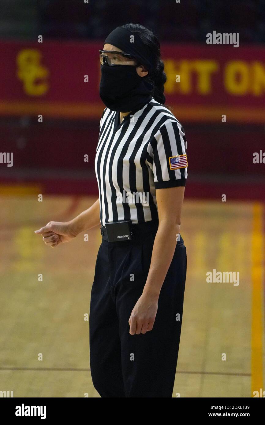 Referee Kaili Kimura wears a face mask and glasses during an NCAA college women's basketball game between the Southern California Trojans and the Long Stock Photo