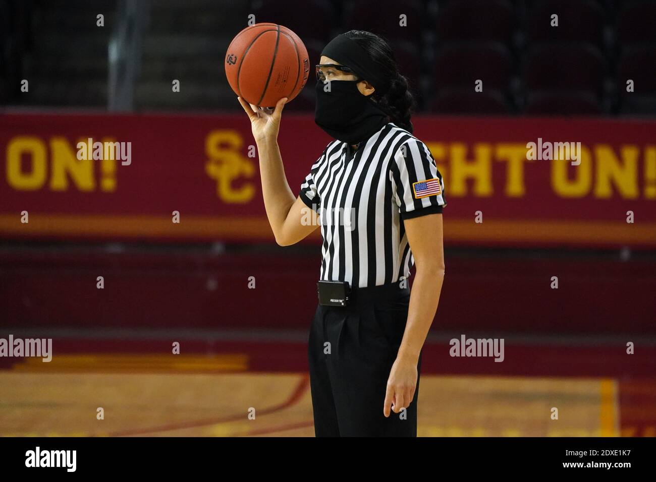 Referee Kaili Kimura wears a face mask and glasses during an NCAA college women's basketball game between the Southern California Trojans and the Long Stock Photo