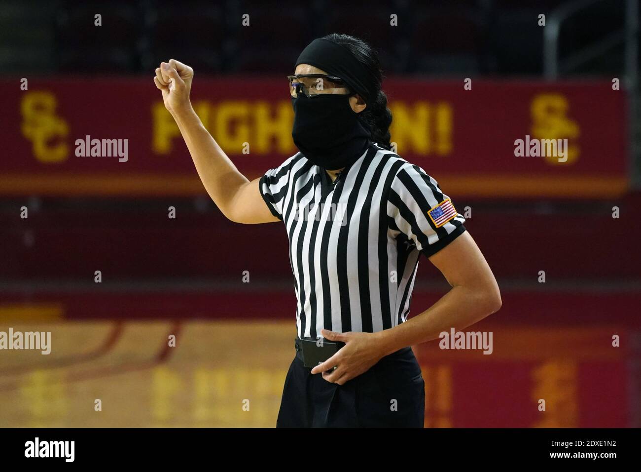 Referee Kaili Kimura wears a face mask and glasses during an NCAA college women's basketball game between the Southern California Trojans and the Long Stock Photo