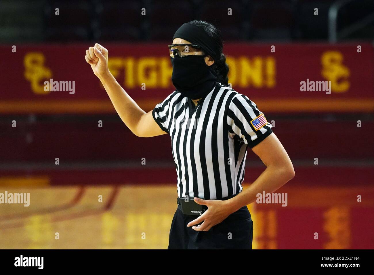Referee Kaili Kimura wears a face mask and glasses during an NCAA college women's basketball game between the Southern California Trojans and the Long Stock Photo