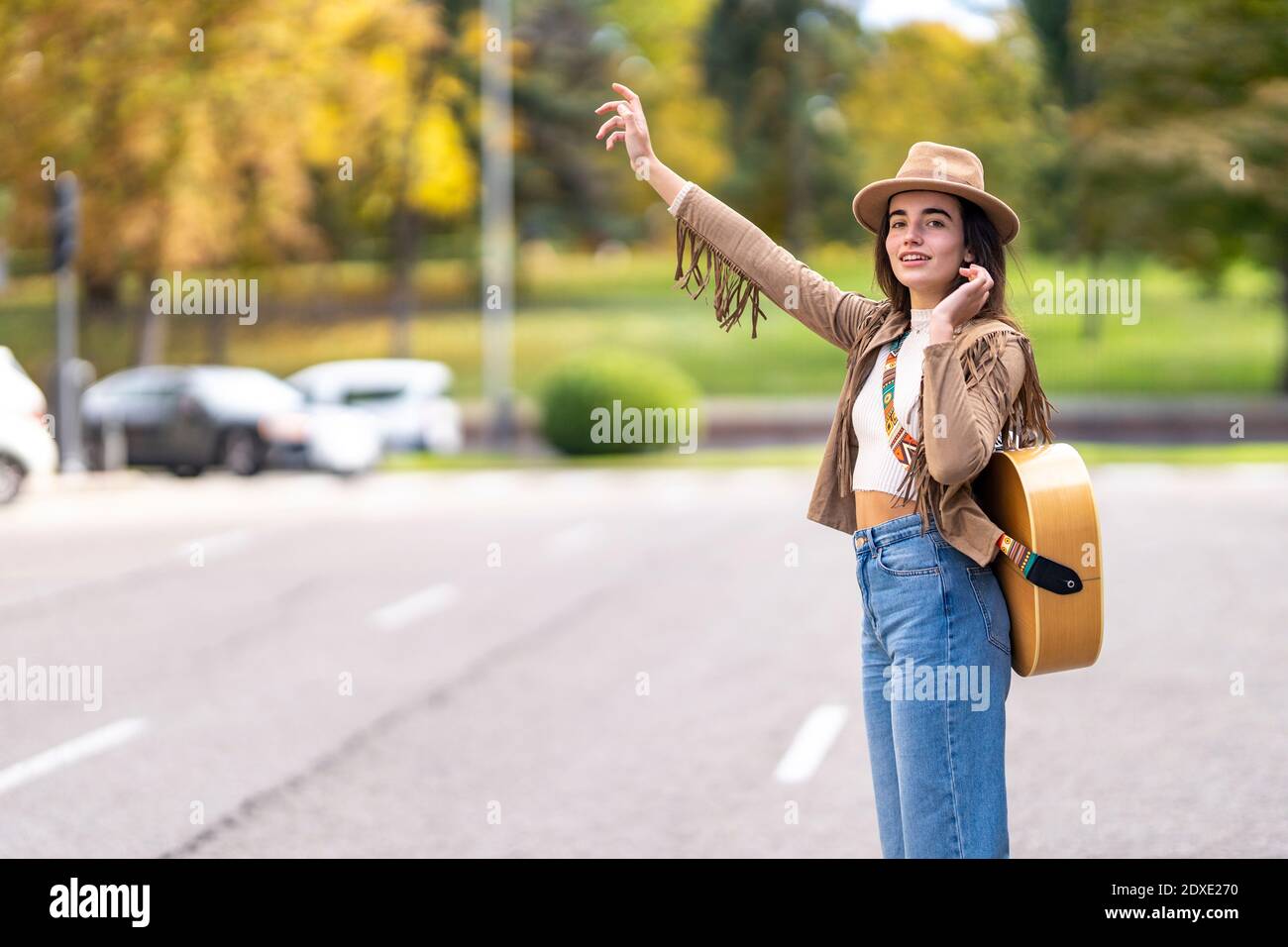 Young musician waving hand on street Stock Photo