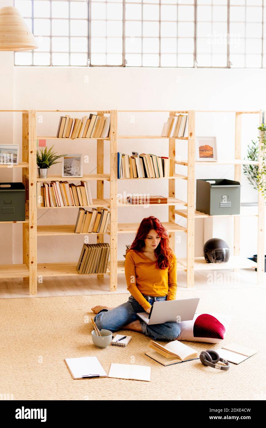 Woman using laptop while studying at home Stock Photo