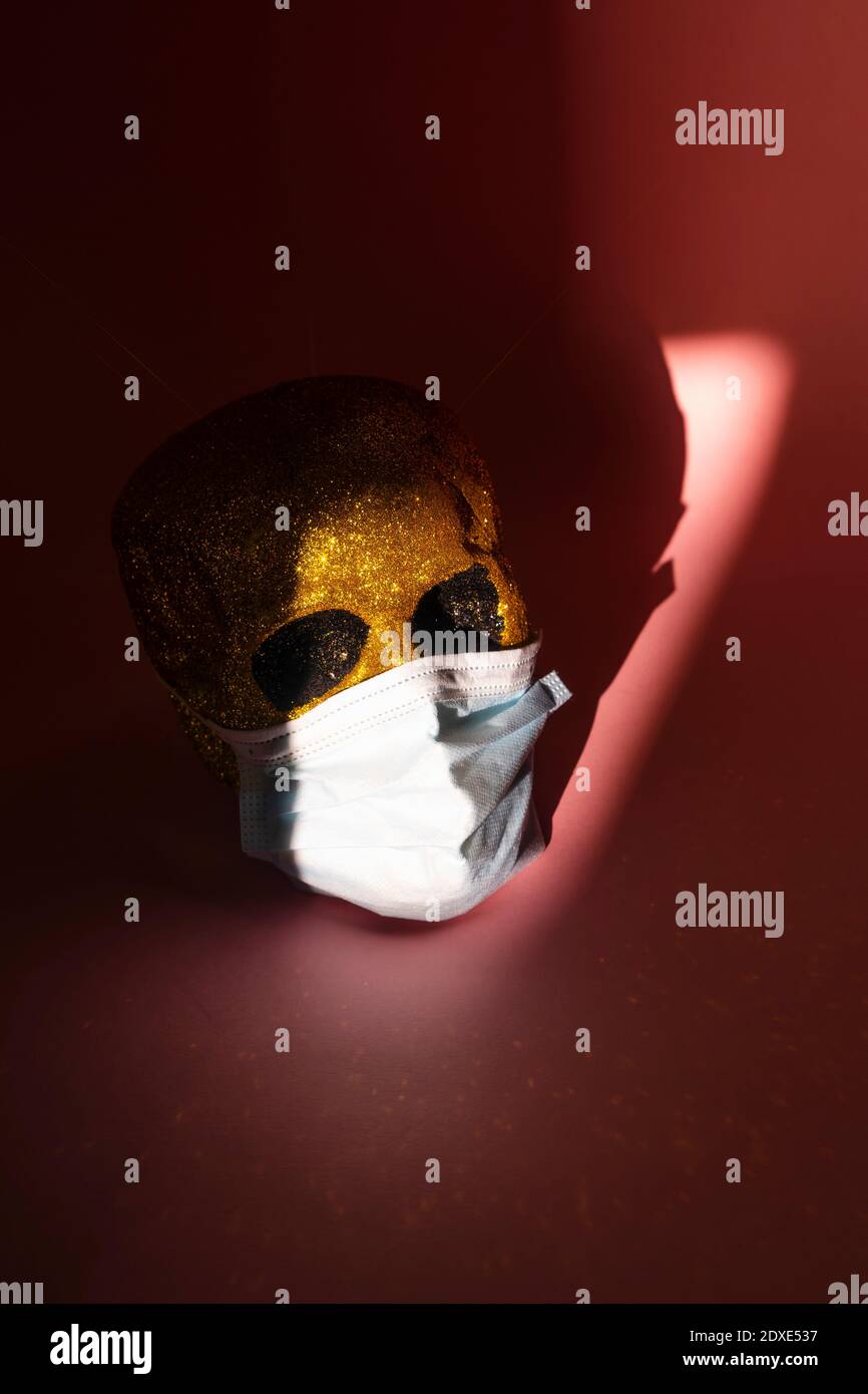 Studio shot of human skull wearing protective face mask Stock Photo