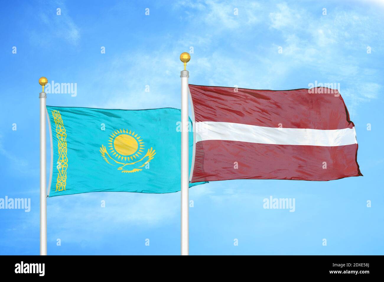 Kazakhstan and Latvia two flags on flagpoles and blue sky Stock Photo