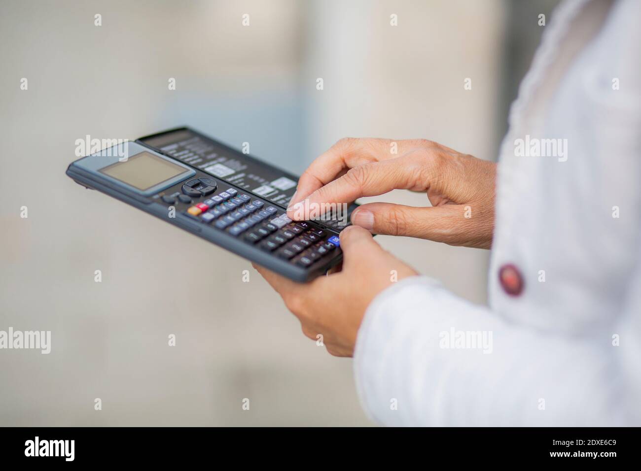 Businesswoman using calculator for accuracy Stock Photo