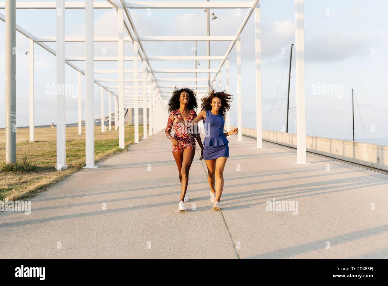 Cheerful young female friends walking Stock Photo