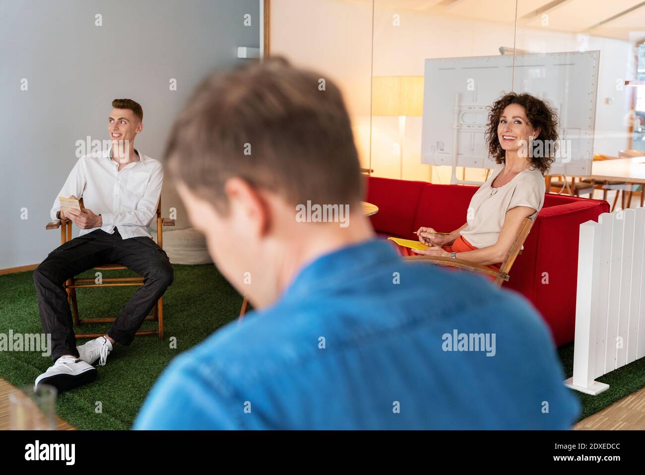 Business people working while sitting together at office Stock Photo