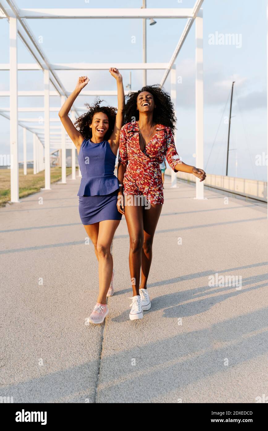 Carefree young female friends walking Stock Photo