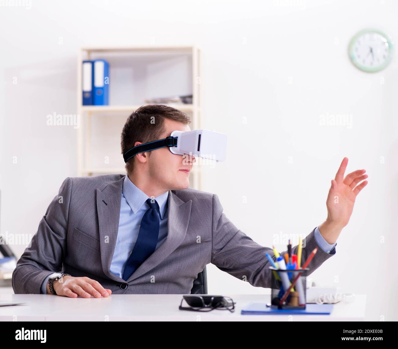 The businessman with virtual reality glasses in office Stock Photo - Alamy