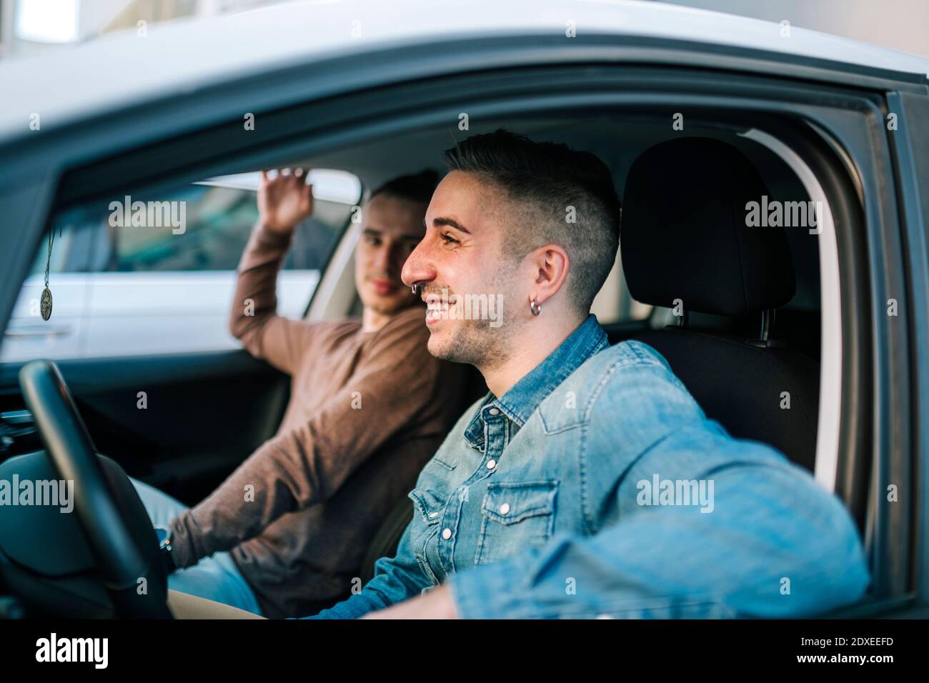 Smiling gay men sitting in car Stock Photo