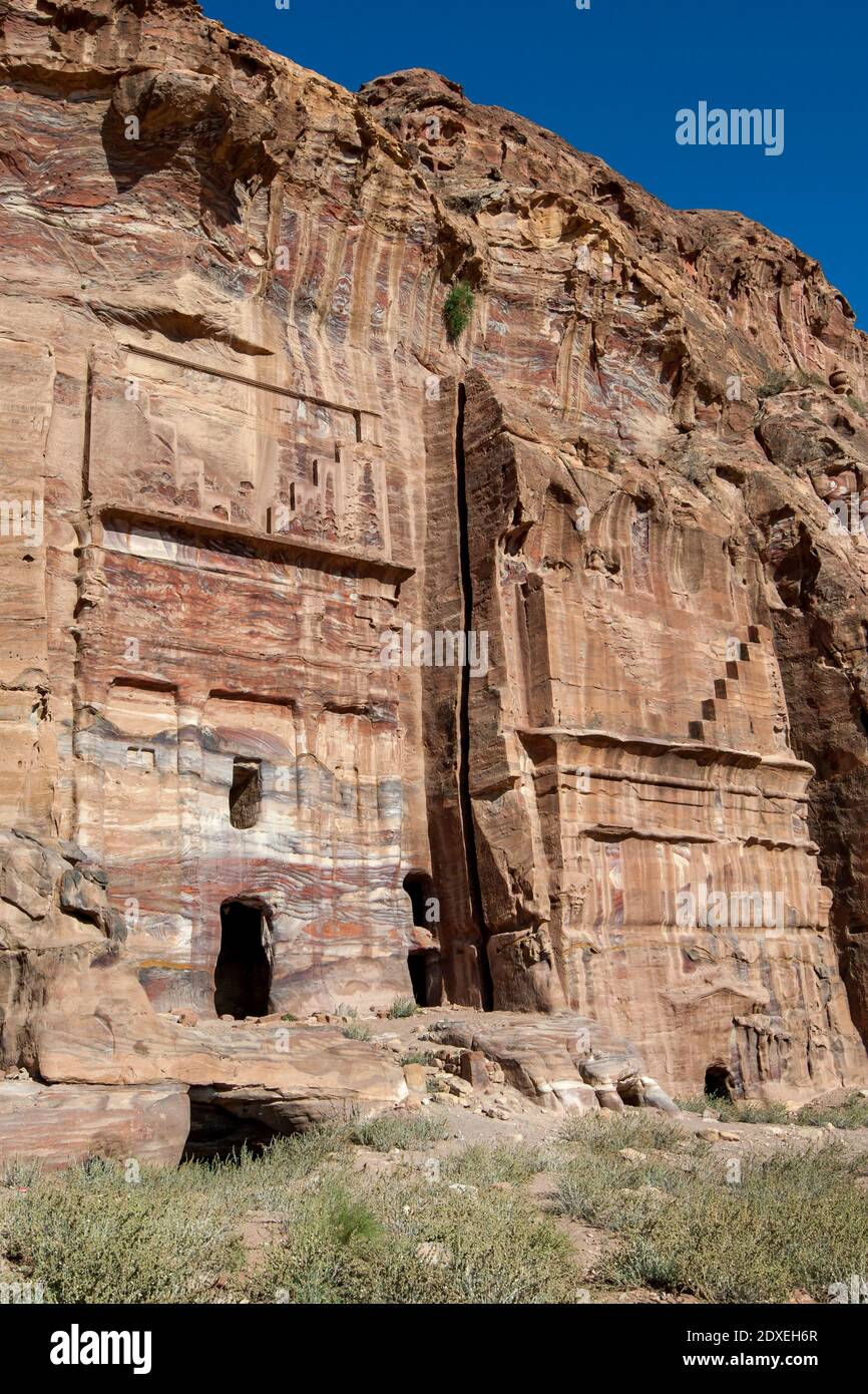 The ruins of the Silk Tomb, one of the Royal Tombs at the ancient site of Petra in Jordan. The tomb is located above Facades Street on the cliff face. Stock Photo