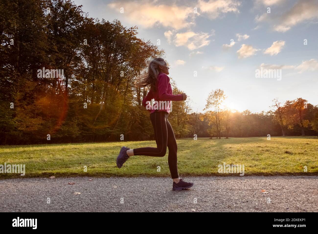 Active woman running in public park Stock Photo Alamy
