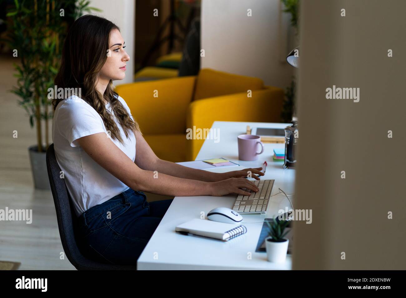 Young businesswoman typing on computer keyboard at office Stock Photo