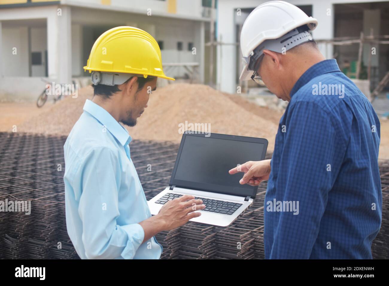Engineering use computer at work building construction background Stock Photo Alamy