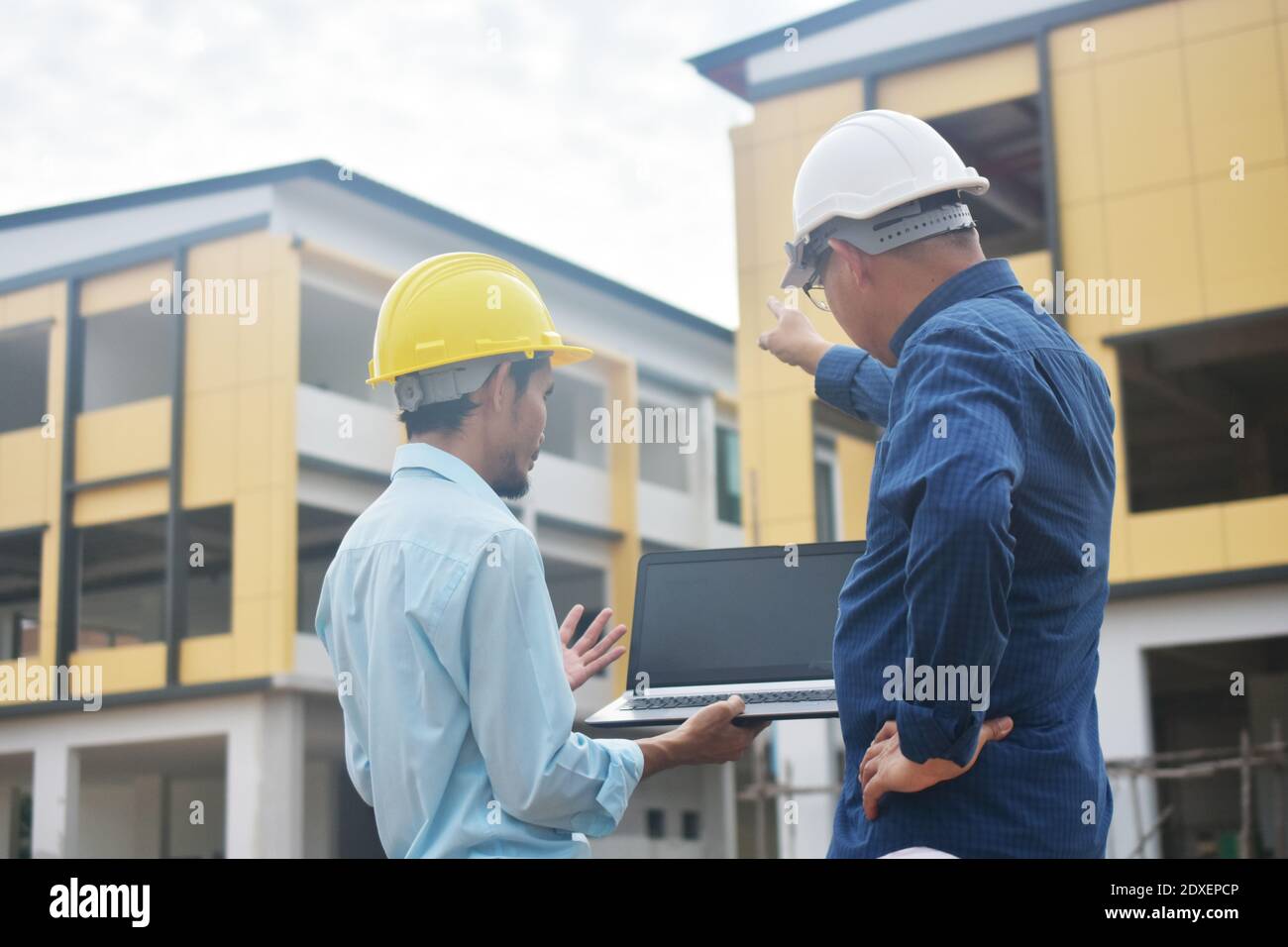 Two Engineering use computer notebook presentation at work place building estate construction background Stock Photo