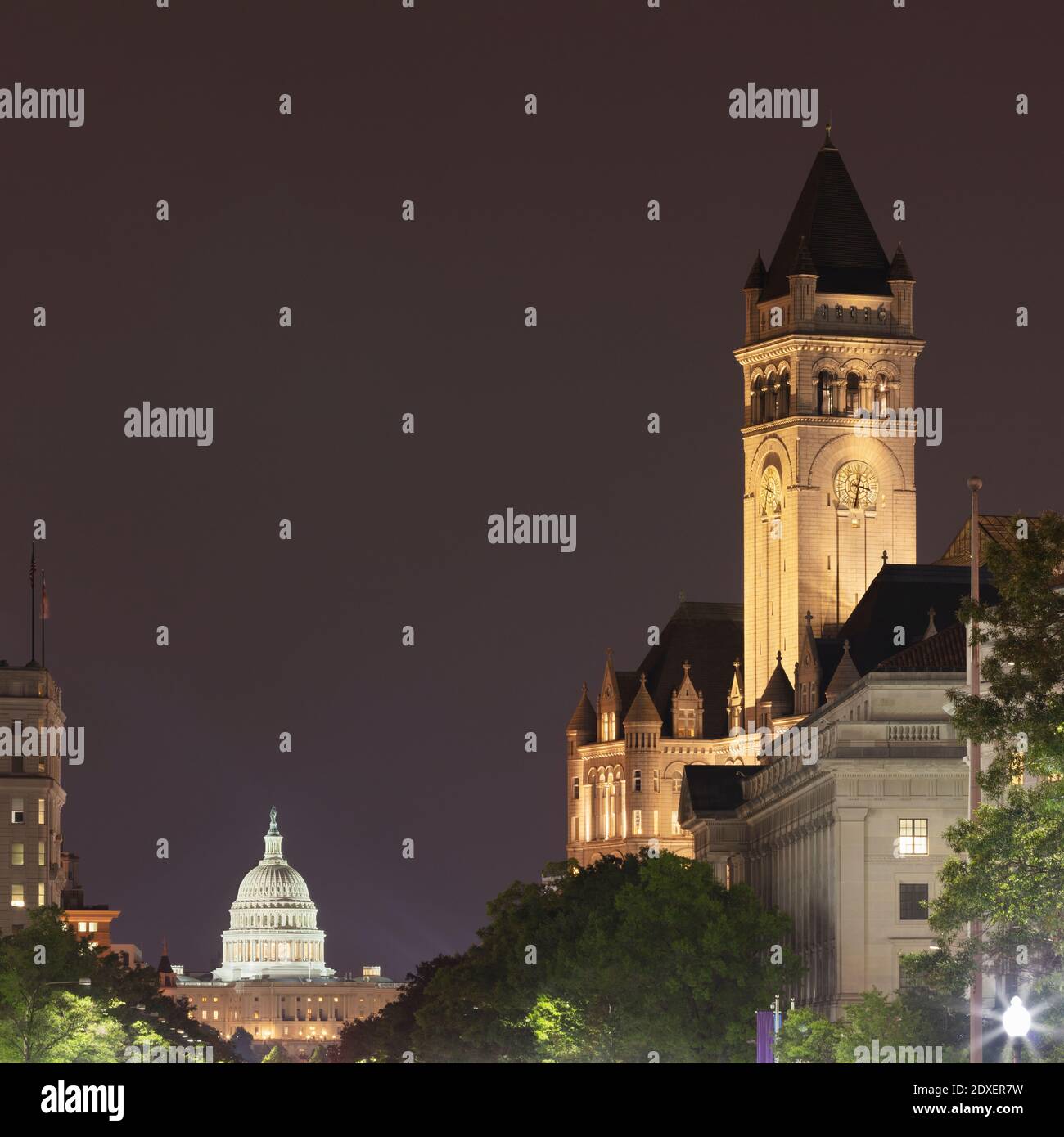 USA, Washington DC, Tower of Old Post Office at night with United States Capitol in background Stock Photo