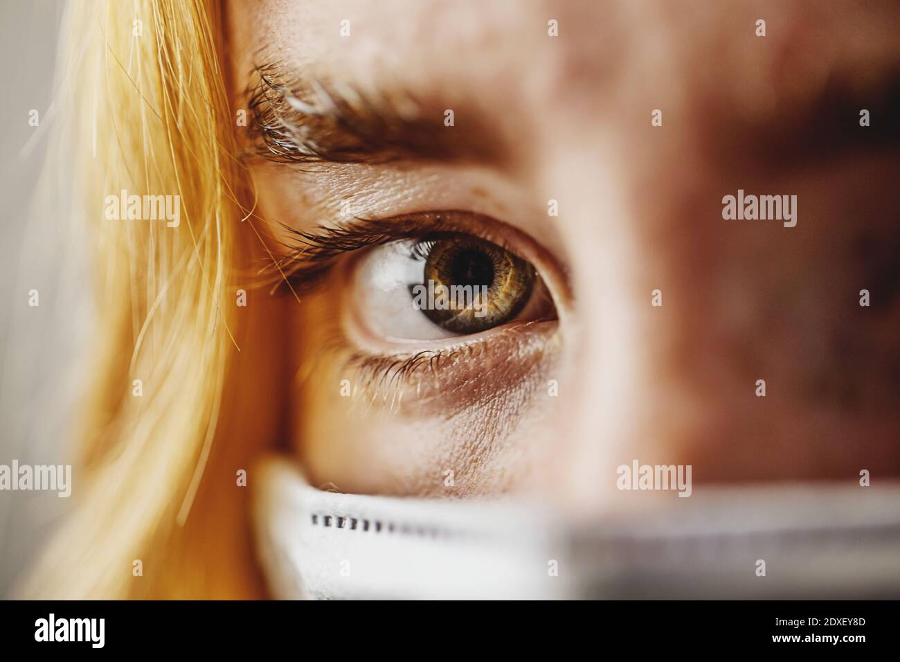 Close-up of teenage girl eyes wearing protective face mask Stock Photo