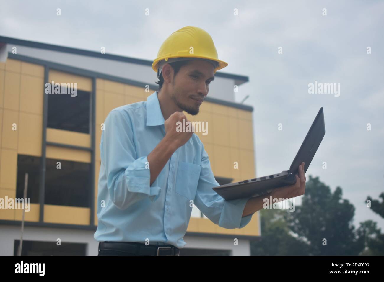 Engineering use computer notebook presentation at work place building estate construction background Stock Photo