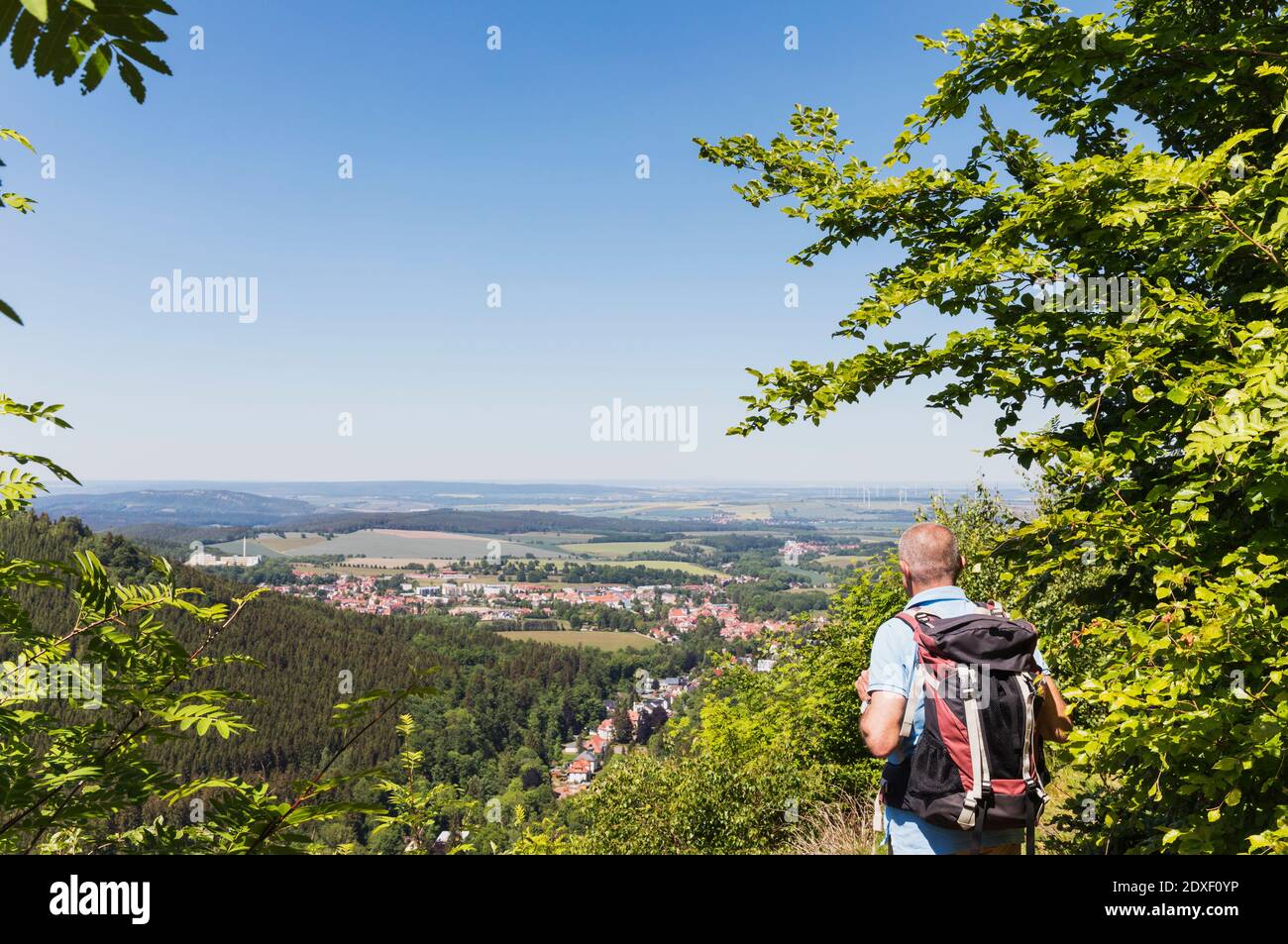 Germany, Thuringia, Bad Tabarz, Senior hiker admiring view of town in Thuringian Forest during spring Stock Photo