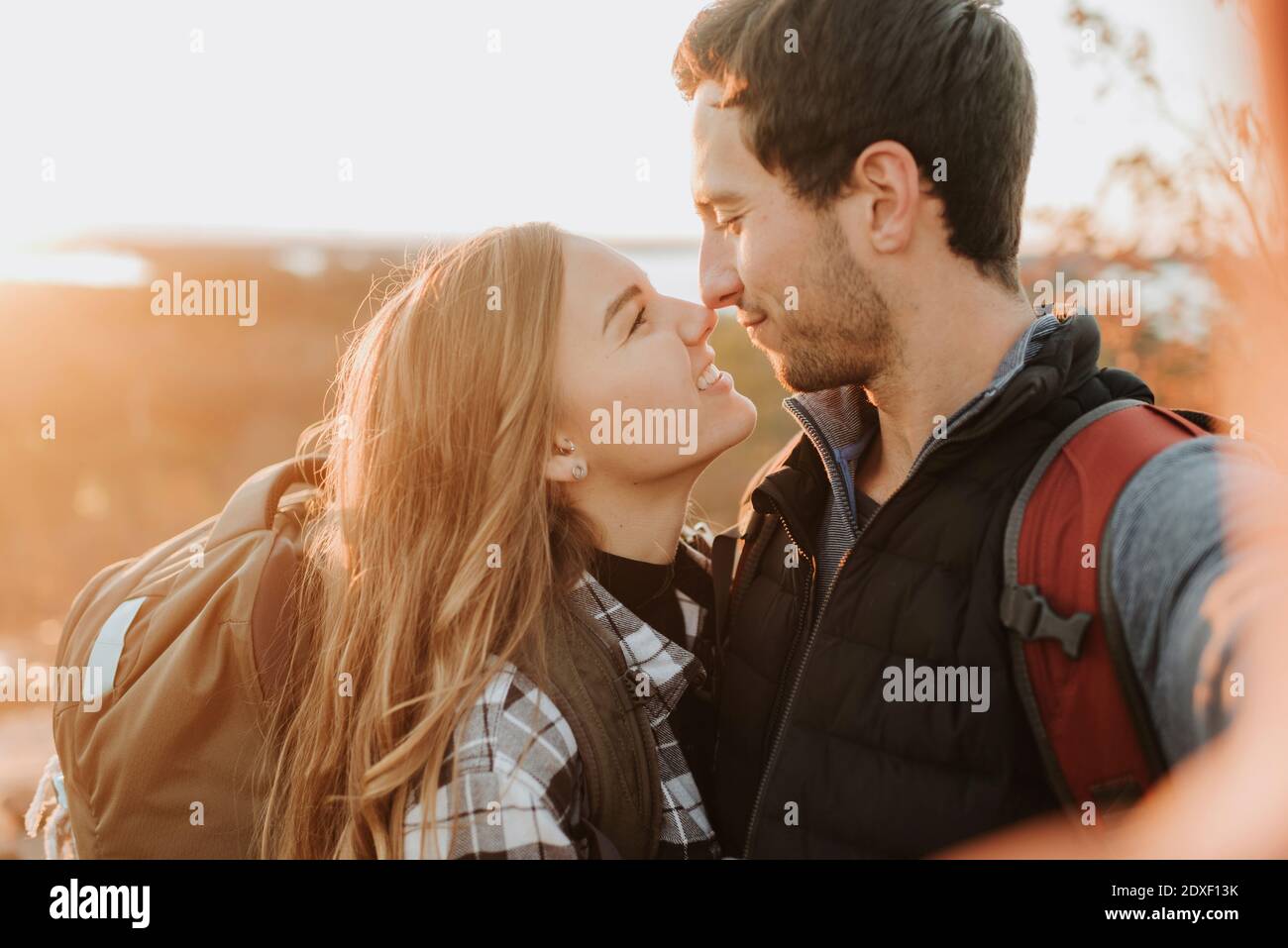 Portrait of young couple affectionately looking at each other during autumn hike Stock Photo