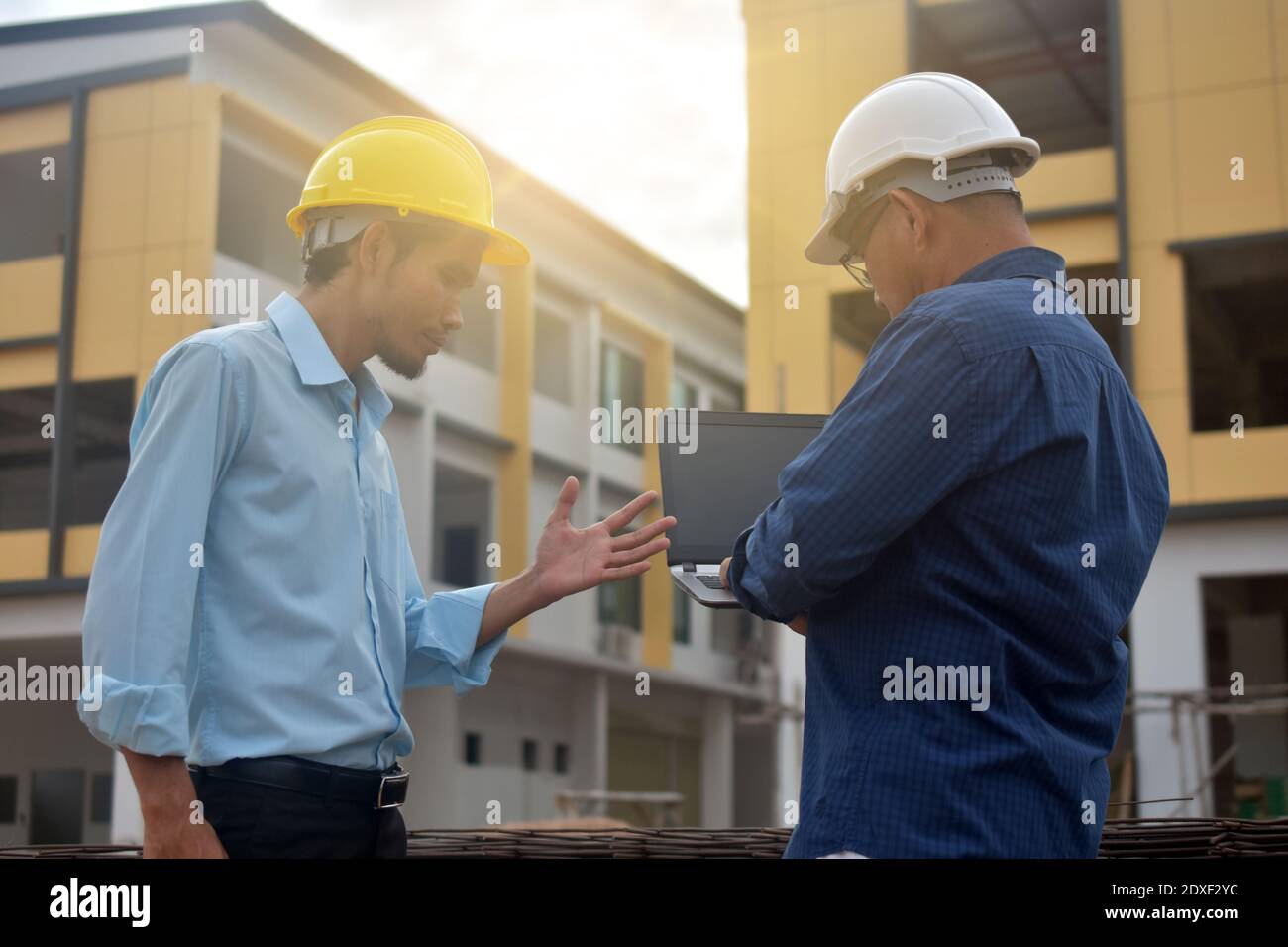 Two Engineering use computer notebook presentation at work place building estate construction background Stock Photo