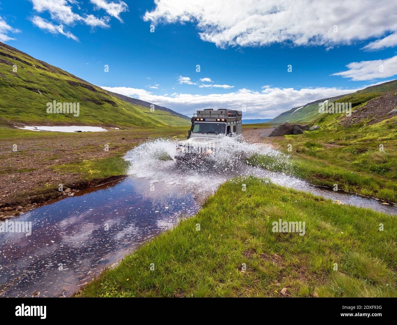 Off-road car crossing river on way to Drangajokull glacier Stock Photo