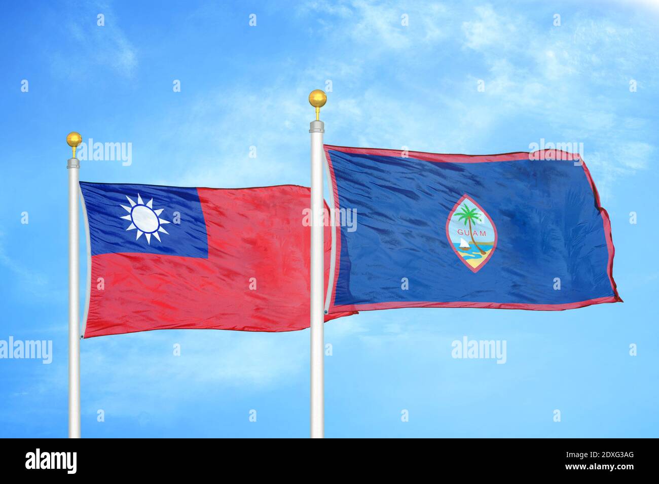Taiwan and Guam two flags on flagpoles and blue sky Stock Photo