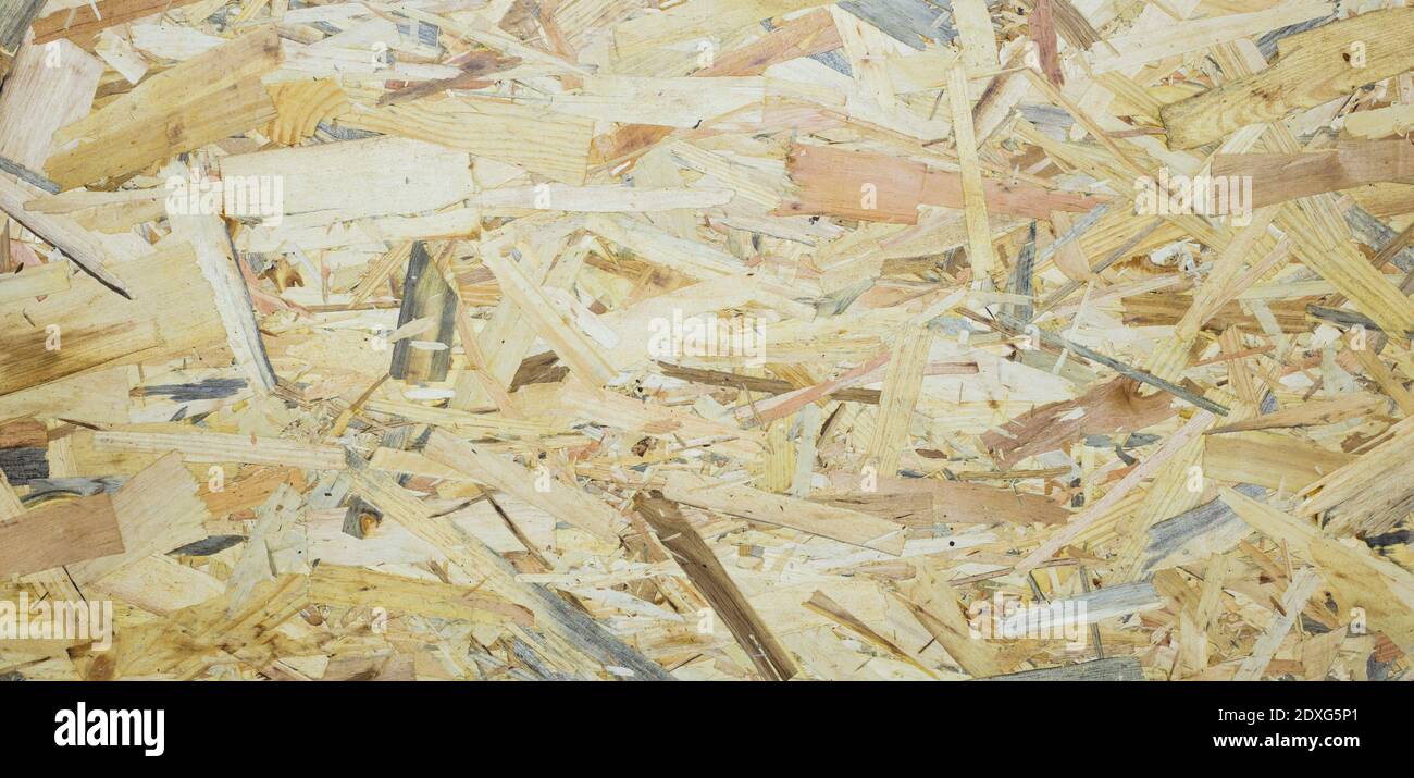 A Fiberboard. Compressed light brown wooden plywood texture. Close up