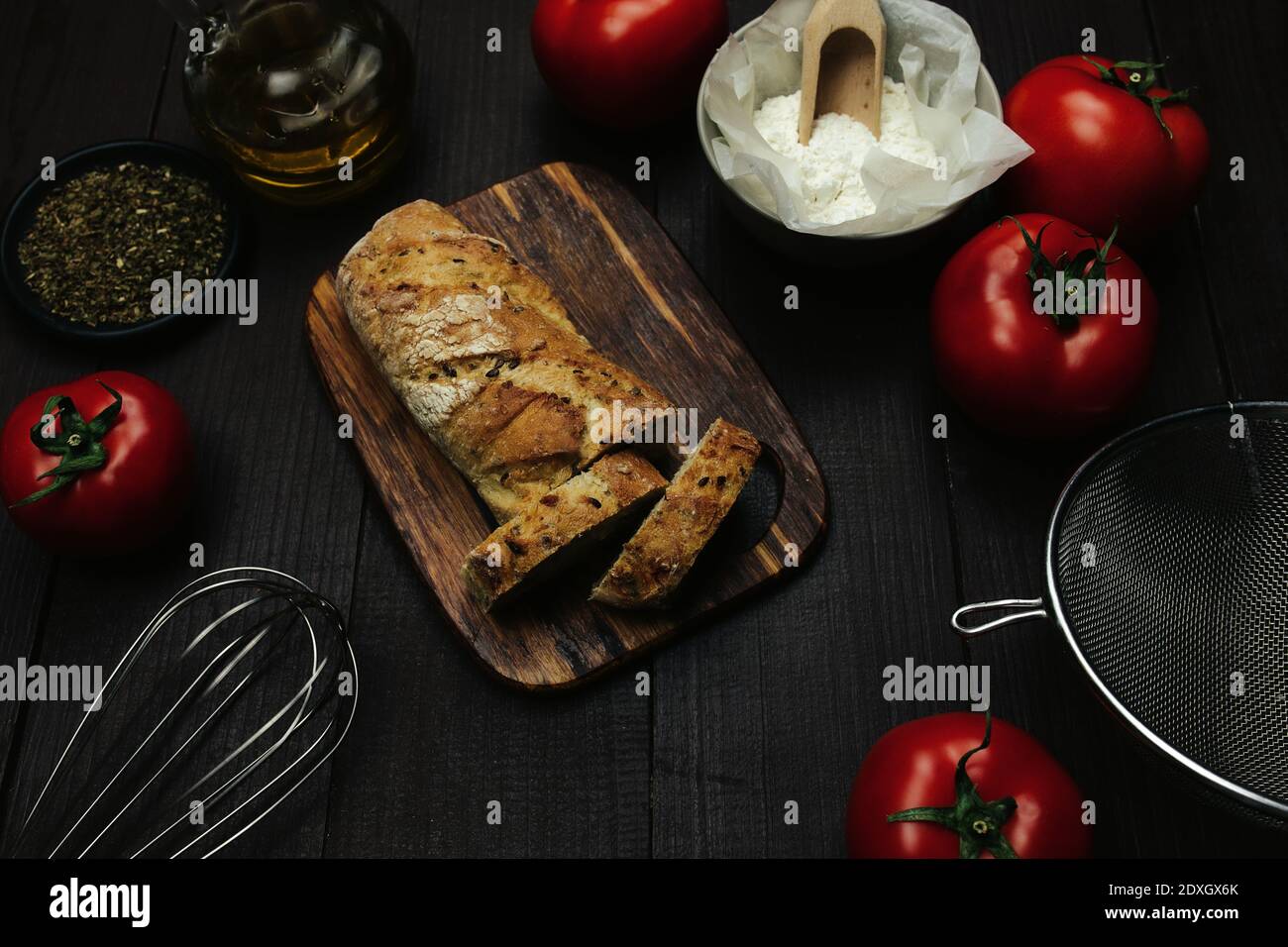 Fresh baked bread and baking ingredients on a table  Stock Photo