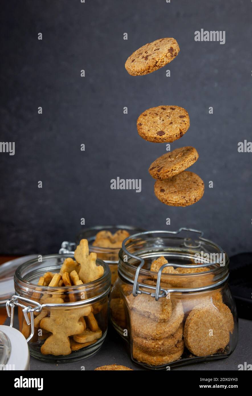 Round homemade cookies flies in a jar. Levitating cookies. Biscuit sweet pastries homemade flour products. Stock Photo