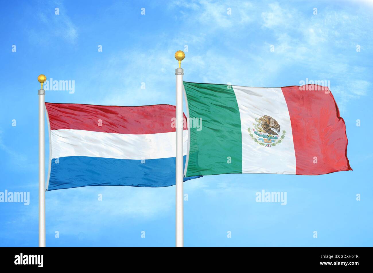 Netherlands and Mexico two flags on flagpoles and blue sky Stock Photo