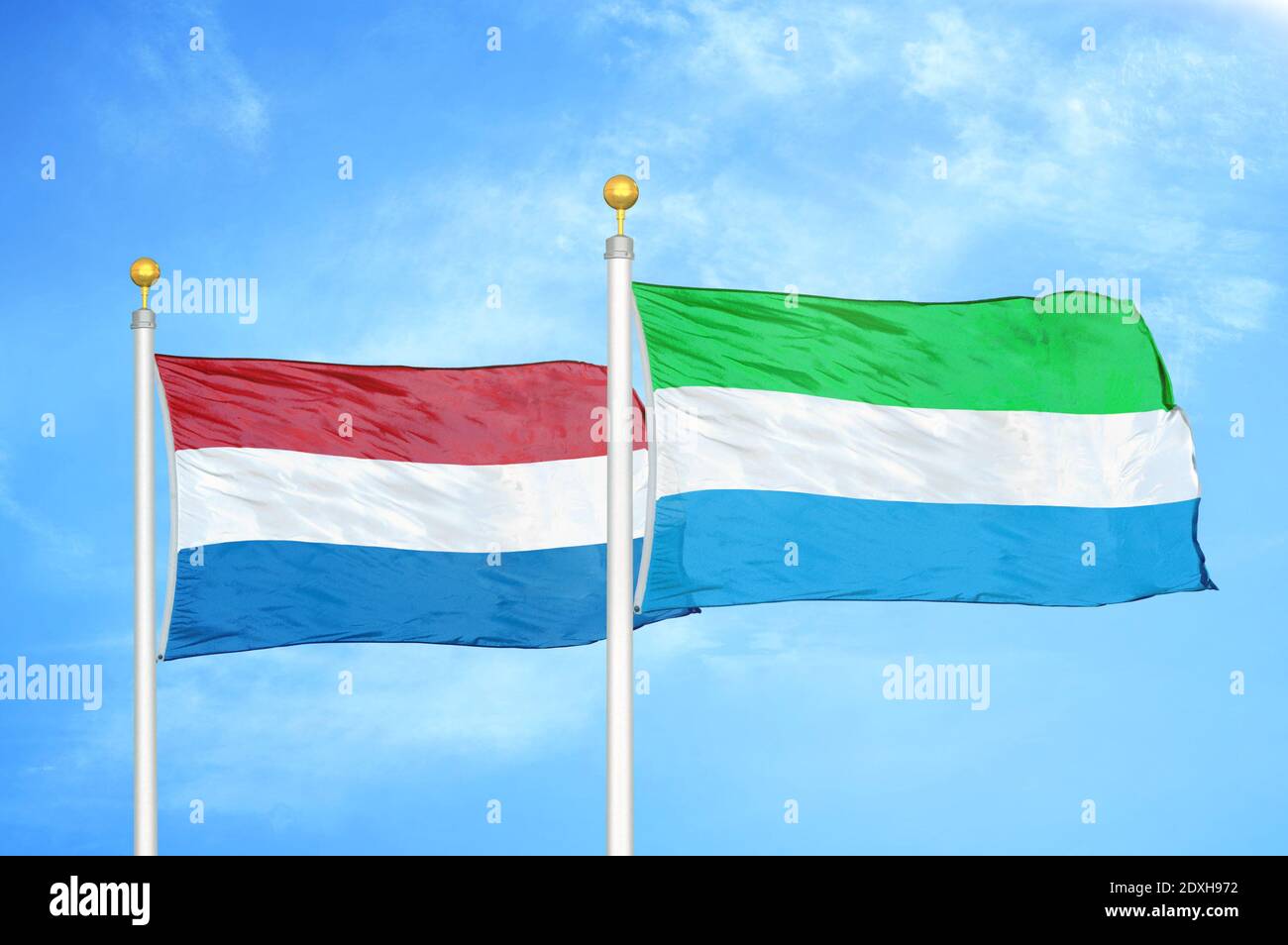 Netherlands and Sierra Leone two flags on flagpoles and blue sky Stock Photo