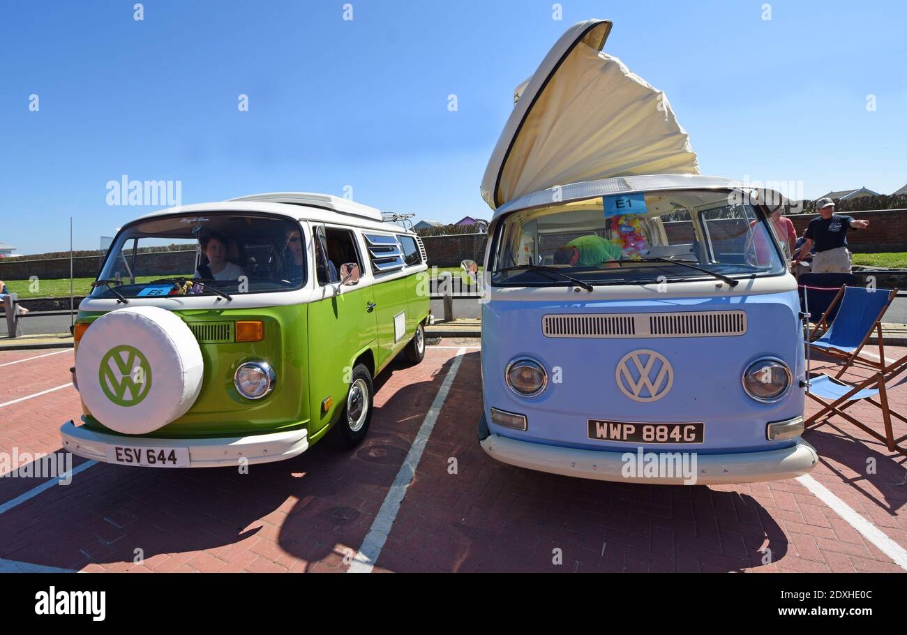 Two Classic VW Camper Vans parked in  seaside car park. Stock Photo