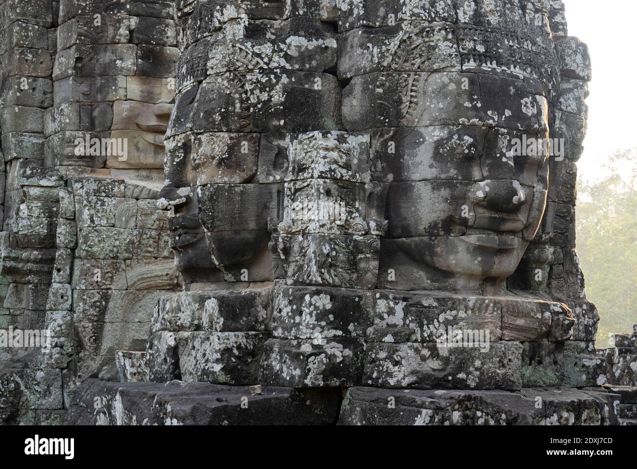 Large face carved into the wall of a temple in Angkor Thom Stock Photo